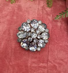 Riveted Austria crystal vintage brooch. Stunning round brooch with pale blue crystal stone in various sizes arranged into a round floral design.  Circumference- 35mm Roll top clasp  Riveted back Super sparkly piece!! Would look beautiful on any garment. Box not included display purposes only. Elegant Round Brooches With Rhinestones, Elegant Round Rhinestone Brooches, Elegant Round Crystal Brooches, Round Rhinestone Brooches For Formal Occasions, Formal Round Brooches With Rhinestones, Round Formal Brooches With Rhinestones, Formal Round Rhinestone Brooches, Silver Jeweled Wedding Brooches, Silver Jeweled Wedding Brooch