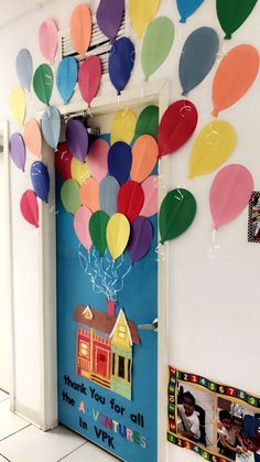 a classroom door decorated with balloons and pictures