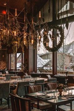 an empty restaurant with tables and chairs in front of large windows