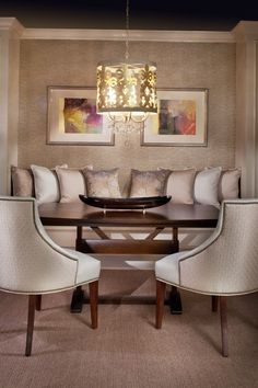 a dinning room table with chairs and a chandelier hanging from the ceiling