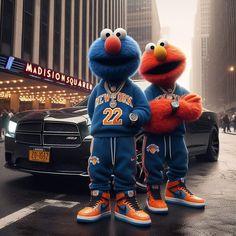 two sesame street characters standing in front of a car