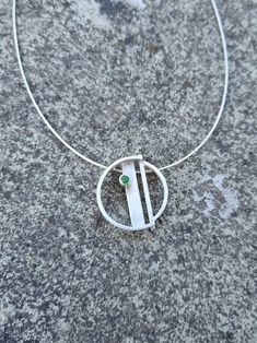 Brushed Silver circular pendant, with chrome diopside. Hung on a silver neckline with lobster catch.