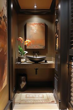 a bathroom with a sink, mirror and art work on the wall behind it's doors