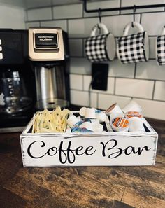 a coffee bar sign sitting on top of a wooden table