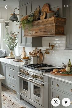 a kitchen with gray cabinets and white counter tops, wooden shelves above the stove top