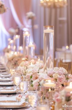 a long table is set with candles and flowers for a formal dinner or wedding reception