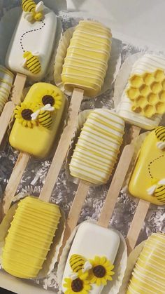 a box filled with lots of yellow and white desserts