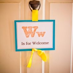 a welcome sign hangs on the front door