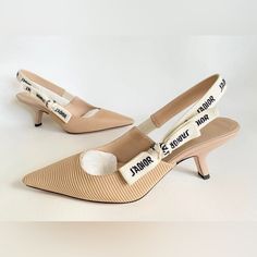 The J'adior Slingback Pump Is A Prime Example Of Dior's Savoir-Faire. Crafted In The Christian Dior Italian Ateliers, The Silhouette Is Distinguished By Nude Technical Fabric. The Two-Tone Embroidered 'J'adior' Ribbon Is Embellished With A Flat Bow And The 6.5 Cm Comma Heel Offers The Final Elegant Touch. 'J'adior' Two-Tone Embroidered Cotton Ribbon Flat Bow Leather Sole With Star, Christian Dior's Lucky Symbol Made In Italy Beige Kitten, Dior Fabric, Dior Slingback, Kitten Heel Slingbacks, Ribbon Flats, Fabric Sandals, Elegant Pumps, Kitten Heel Shoes, Slingbacks