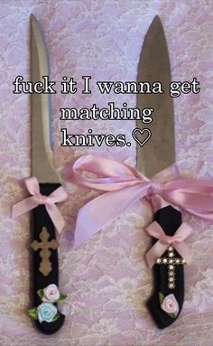 two knives with pink ribbons tied to them, one has a cross on it and the other has a bow