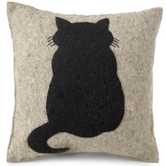 a black cat sitting on top of a gray and white pillow with an embroidered back