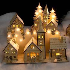 lighted houses in the snow at night