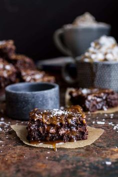 two pieces of brownie sitting on top of a table