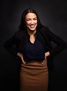 a woman smiling and standing with her hands on her hips