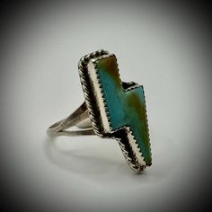 Super cool turquoise lightning ring.  This is truly a unique piece.  This statement ring is carefully handmade with simple sterling silver work and gorgeous turquoise stones which has been carved into a lightning shape. If you love Navajo jewelry, you will love this sterling silver ring. It measures about 1 inch long and is a substantial piece, yet comfortable enough to be easy to wear.  This ring is a size 8. This statement ring is sure to get you noticed!  It would make a lovely anniversary gi Lightning Ring, Statement Rings Unique, Silver Handmade Jewelry, Handmade Jewelry Ring, Navajo Jewelry, Silver Work, Turquoise Stones, Turquoise Rings, Gift For Girlfriend