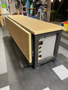 a workbench in a garage with tools on the floor