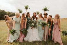 a group of women standing next to each other in a field