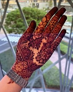 a woman's hand with henna on it