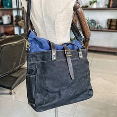 The Woosir Roll Top Canvas Tote with Shoulder Strap and Laptop Sleeve is a stylish and functional bag designed for everyday use. It is made from a waterproof canvas material and features a roll-top closure, an adjustable shoulder strap, and a comfortable carrying handle. The bag also comes with a laptop sleeve for extra protection, two interior pockets for extra storage, and one exterior pocket for quick access items. This bag is perfect for carrying laptops, tablets, books, documents, and other items.  ITEM FEATURES   
- 1 x Main Compartment 
- 1 x Laptop Compartment 
- 1 x Interior Zipper Pocket 
- 2 x Slot Pockets 
- 2 x Side Pockets 
- 1 x Back Zipper Pocket 
- Roll Top Design 
- Detachable Shoulder Strap 
- Waterproof& Durable 
- Hold 14" Laptop 
 
 
  
 ITEM DETAILS   
*Item Type: To Practical Canvas Bag With Adjustable Strap, Practical Canvas Bag With Adjustable Strap For Outdoor, Outdoor Cotton Canvas Bag With Adjustable Strap, Large Capacity Cotton Shoulder Bag For Outdoor, Black Functional Canvas Bag With Canvas Lining, Outdoor Large Capacity Cotton Shoulder Bag, Functional Waxed Canvas Bag With Adjustable Strap, Black Cotton Bag For Outdoor, Black Satchel Canvas Bag For Outdoor