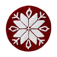 a red and white rug with snowflakes in the center on a white background