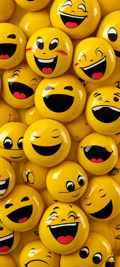 many yellow smiley faces are grouped together in the shape of balls with eyes and mouths