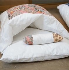 two pillows are folded on top of each other