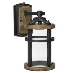 This decorative LED outdoor wall light is a porch lantern fixture with a metal black frame and a wood grain style brown finish featuring a glass lens. This farmhouse wall light features a photocell sensor, also known as a dusk-to-dawn sensor, which can turn your light on and off automatically. This is a great added convenience, allowing you to keep your home safe and well-lit without having to turn the outdoor light on and off manually each day. This vintage style light produces 800 lumens of 30 Outdoor Garage Lights, Porch Lantern, Farmhouse Wall Lighting, Contemporary Sconces, Black Outdoor Wall Lights, Led Outdoor Wall Lights, Garage Lighting, Modern Sconces, Dusk To Dawn