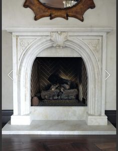 an ornate fireplace with a mirror above it