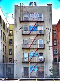 an apartment building with graffiti on the side