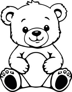 a black and white teddy bear sitting on the ground with its paws crossed in front of it