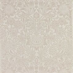 a white and beige wallpaper with floral designs on the back side, in an ornate pattern