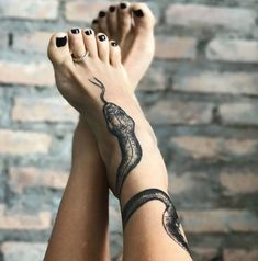 a woman's legs with black and white tattoos on them