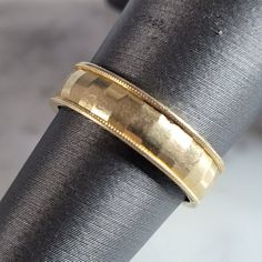 a close up of a gold ring on top of a piece of cloth