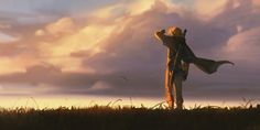 a man standing on top of a grass covered field next to a tall wooden pole