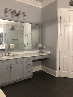 a bathroom with two sinks and a large mirror