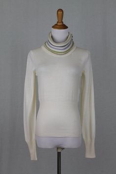 "Cividini Milan Ivory Turtleneck Pullover Sweater Luxurious Italian Superfine Merino wool sweater with long sleeves and a banded waist Pastel purple and green bands accent the neck  100% superfine Merino wool Condition: New without tags Size Italian size 40 USA size 4 (small) Measures: Bust: 34\" Length 23\" sleeves: 26\" shoulders: 16\"" Ivory Turtleneck, Wool Turtleneck Sweater, Turtleneck Pullover, Wool Turtleneck, Pullover Sweater Women, Pastel Purple, Merino Wool Sweater, Beautiful Blouses, Sweater Making