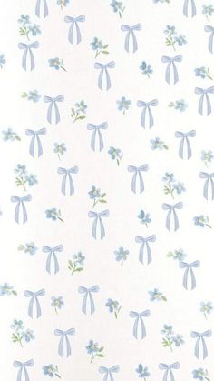 a blue and white wallpaper with bows on it's sides, in the shape of flowers