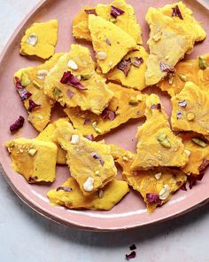 a pink plate topped with cut up pieces of food