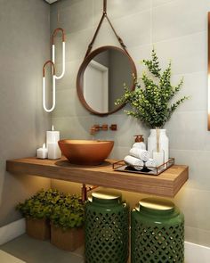 a bathroom with a sink, mirror and green vases on the counter next to it