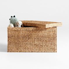 an empty wicker box with stuffed animals in it, on a white background for display