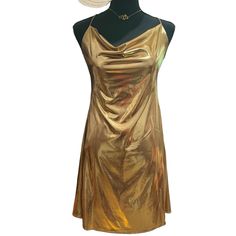 This Glamorous Evening Dress Features A Stunning Metallic Gold Color And Delicate Spaghetti Straps For A Touch Of Elegance. Perfect For Formal Events Or Special Occasions, This Dress Exudes Sophistication And Style. The Shimmering Fabric Catches The Light Beautifully, Making You Stand Out And Shine In Any Evening Setting. The Spaghetti Straps Add A Subtle And Feminine Detail To The Overall Look, Making This Dress A Must-Have For Your Next Glamorous Event. Length: 33" Long Gold Dresses For Spring Costume Party, Gold Dress For Spring Costume Party, Gold Costume Party Dress For Spring, Metallic Spaghetti Strap Dress For Summer, Metallic Spaghetti Strap Summer Dress, Metallic Summer Dress With Spaghetti Straps, Gold Chic Slip Dress With Spaghetti Straps, Chic Gold Slip Dress With Spaghetti Straps, Glamorous Gold Slip Dress For Night Out