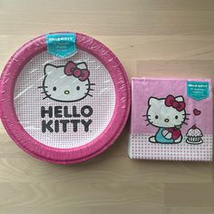 a pink paper plate with hello kitty on it next to a napkin and placemat