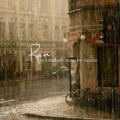 rain falling down on a city street with bicycles parked in front of a building and the words rain is melody sungg by nature