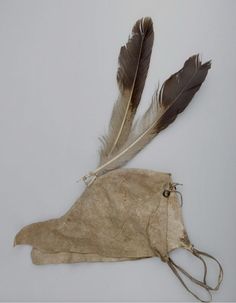 a piece of cloth with two feathers attached to it