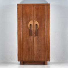 an old wooden cabinet with two doors on the front and one door in the back