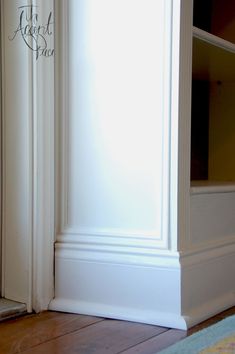 the corner of an empty room with white trim