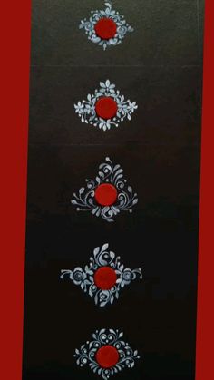 three red and white designs on a black surface