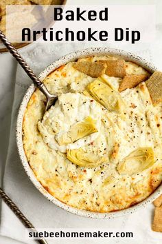 baked artichoke dip in a bowl with crackers