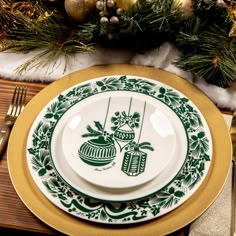 a green and white plate sitting on top of a table next to a christmas tree