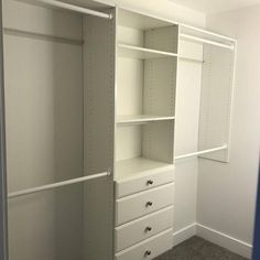 an empty white closet with drawers and shelves